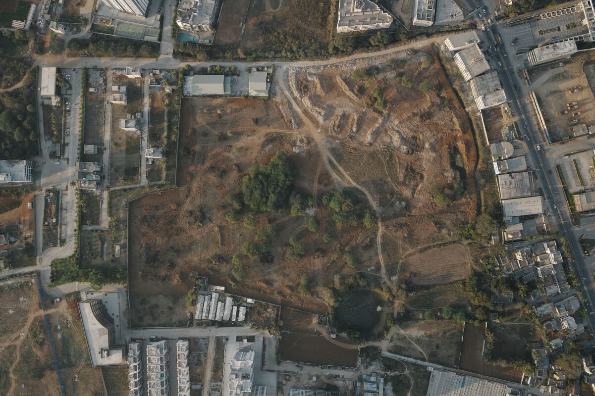 An aerial view of a dry landscape with scattered buildings.