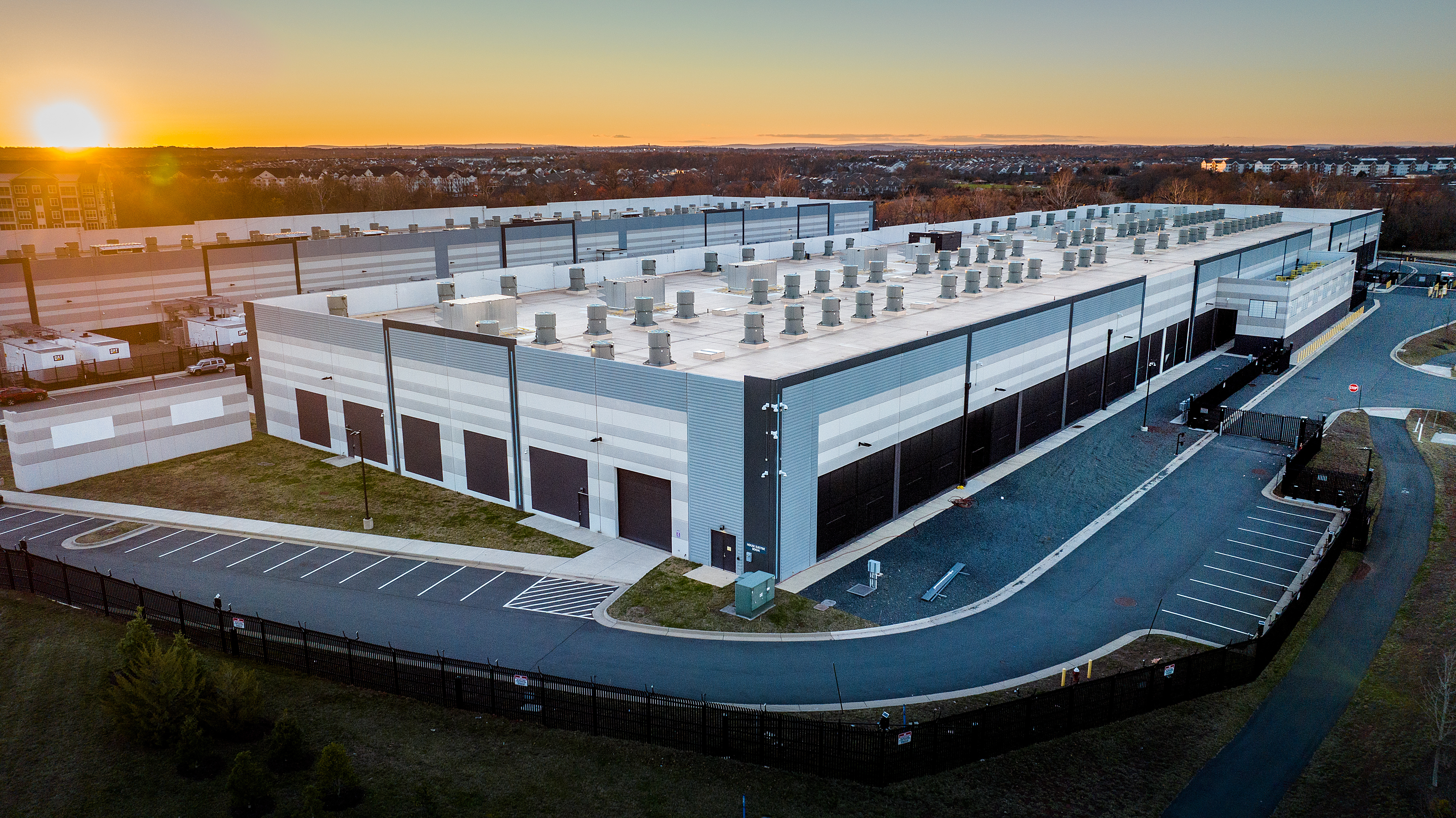 The exterior of a data center building at sunset. 