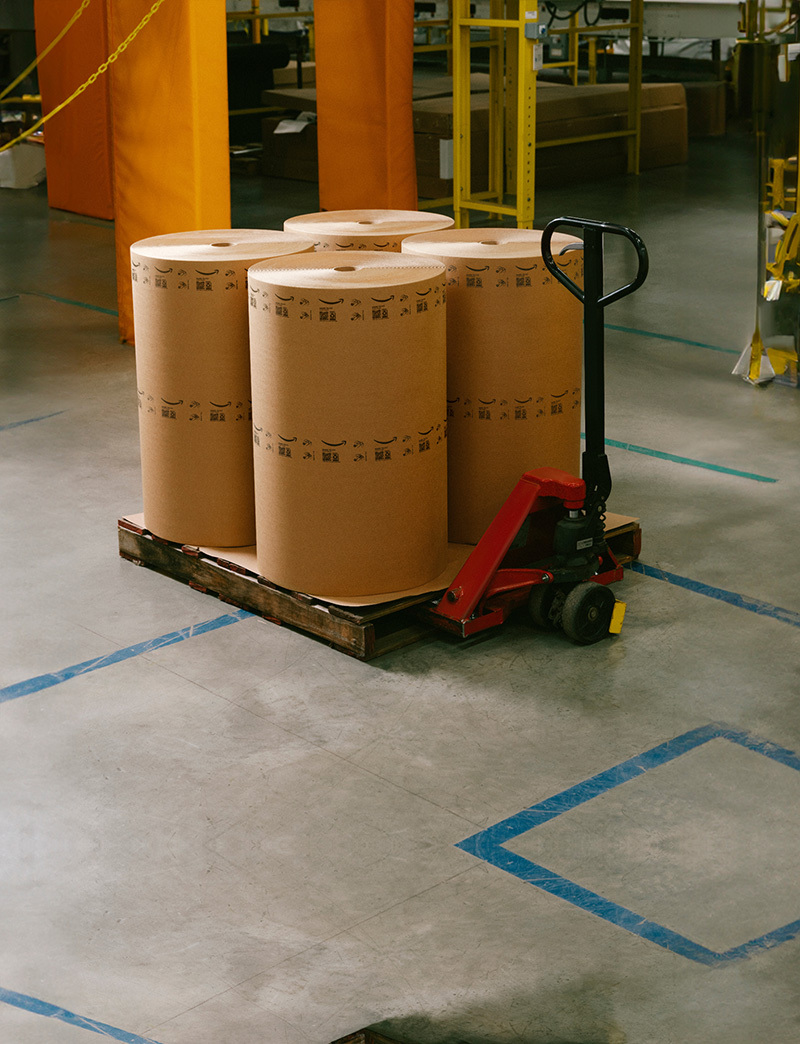 A person works packaging machinery.