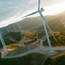 Wind turbines on a hillside at sunset.  