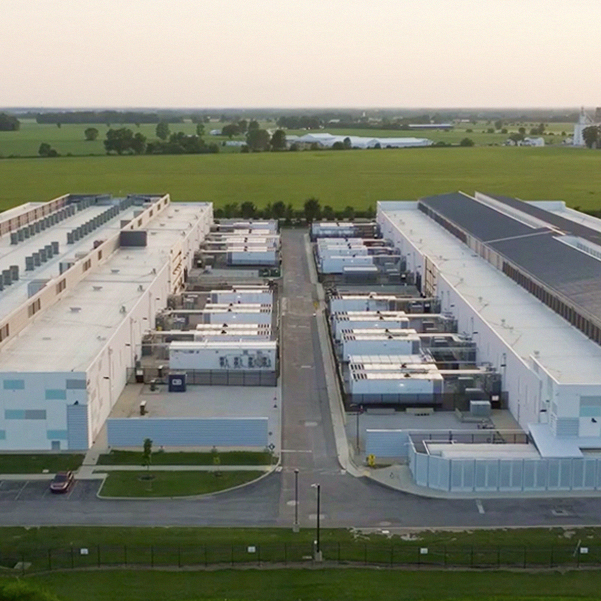 Aerial view of data center complex in rural farmland.