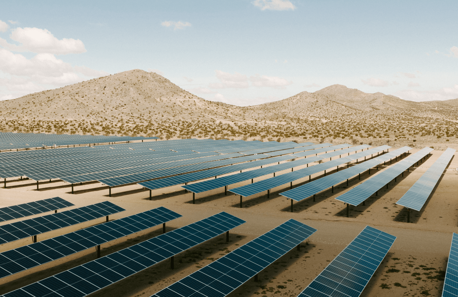 Rows of solar panels in a desert climate. 