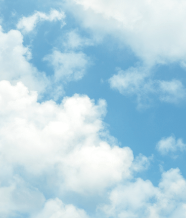 A blue sky with white fluffy clouds. 