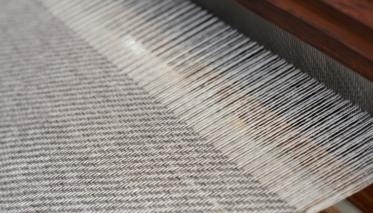 Fabric being woven.