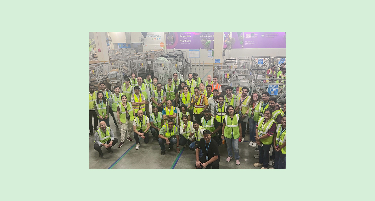A group of people in yellow safety vests smile for the camera.