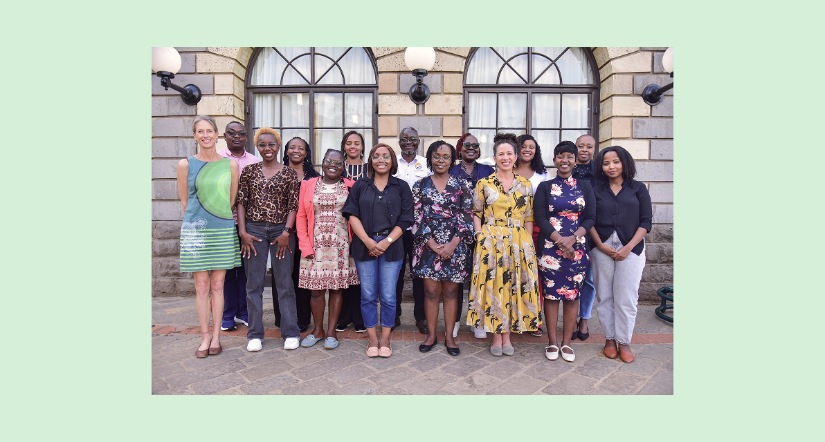 A group of people smiling for a photo at an event. 