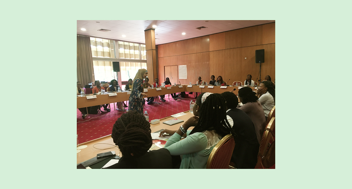 A person speaks to a room of people at an event. 