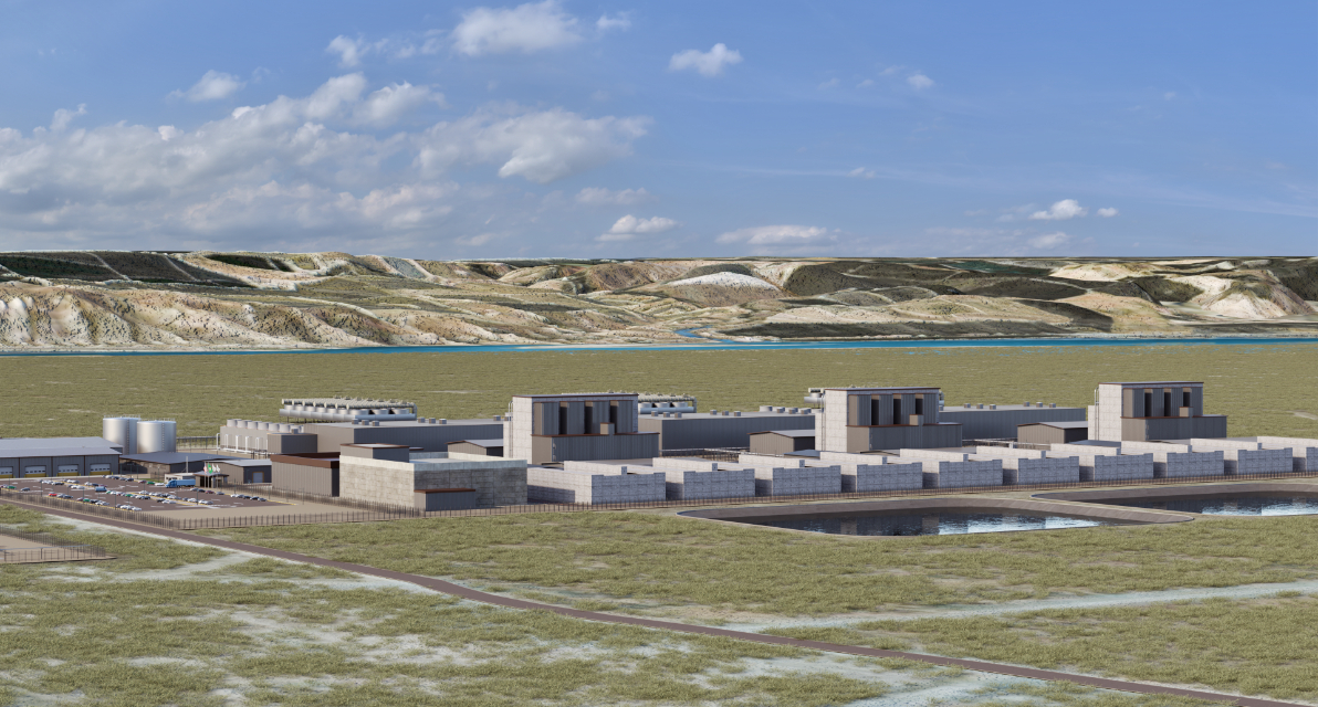 Clusters of buildings in an open landscape with blue sky above and a hillside in the background. 